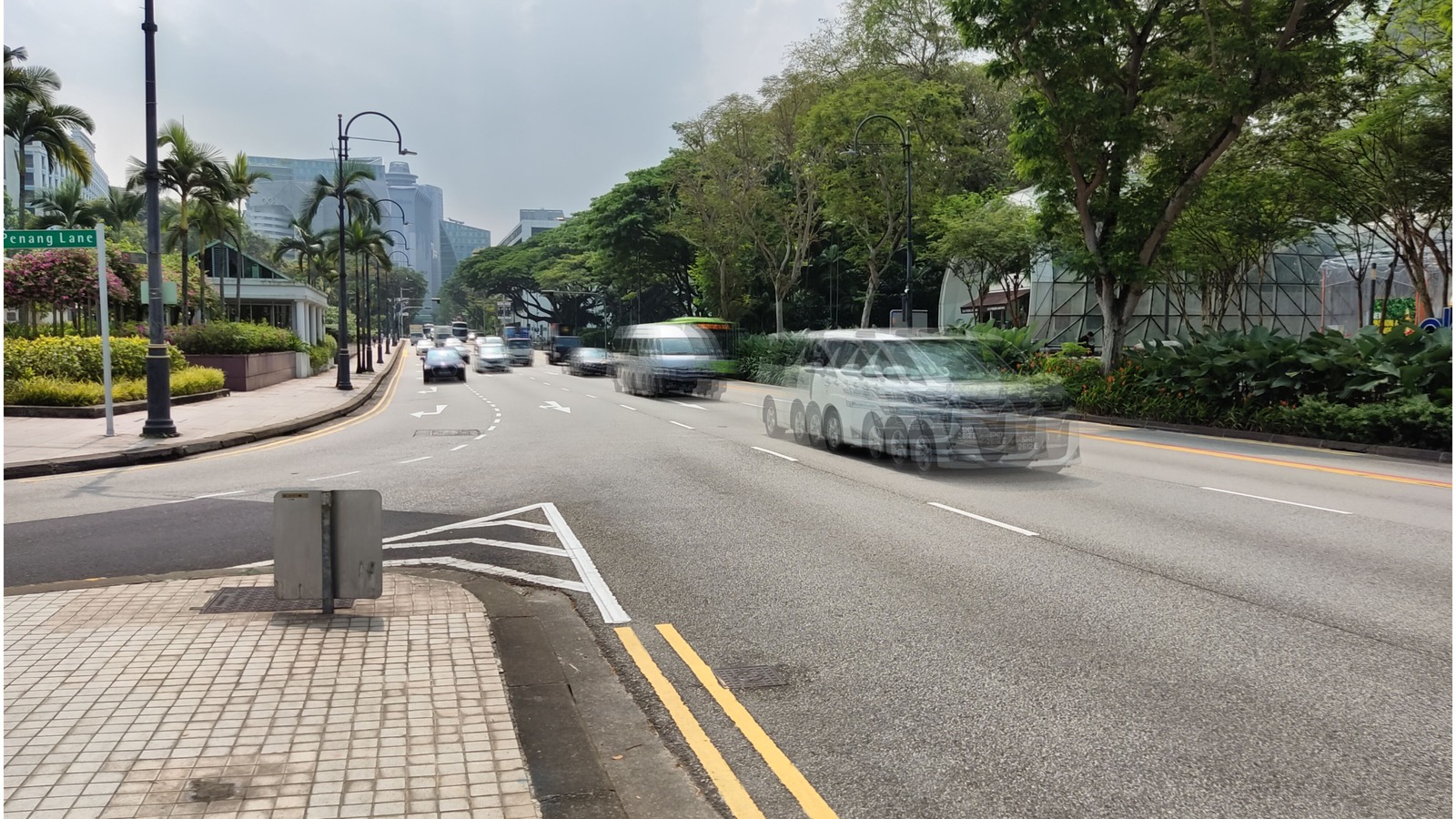 Orchard Road in Singapore looking toward high-rises, with traffic and a Cuscaden Lane sign, 2023
