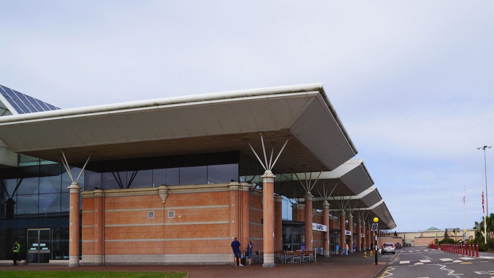Jersey Airport departures terminal exterior with its canopy entrance in St Peter, Jersey