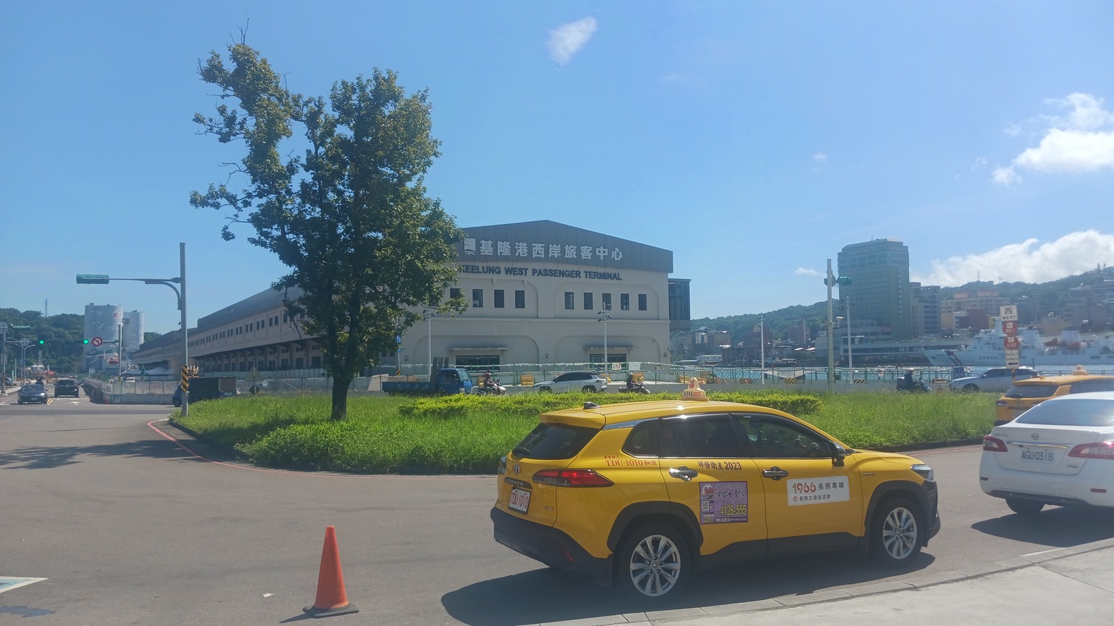 Keelung West Passenger Terminal building and taxis on Gangxi Street in August 2025