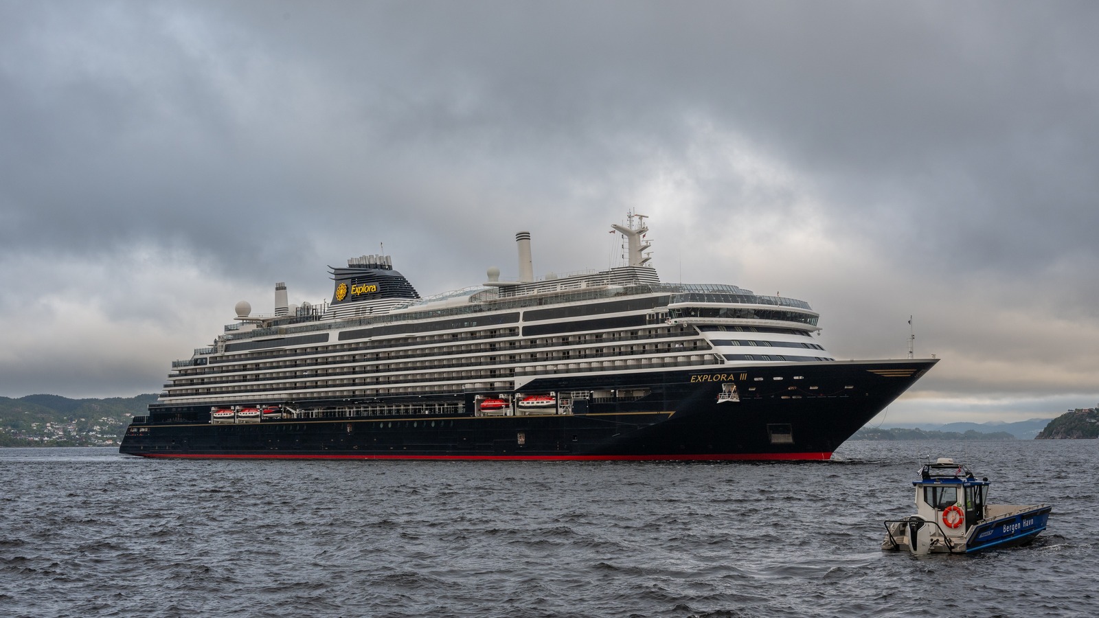 Explora III cruise ship underway in Bergen, Norway, on August 22, 2026, with the ship's name visible on the bow