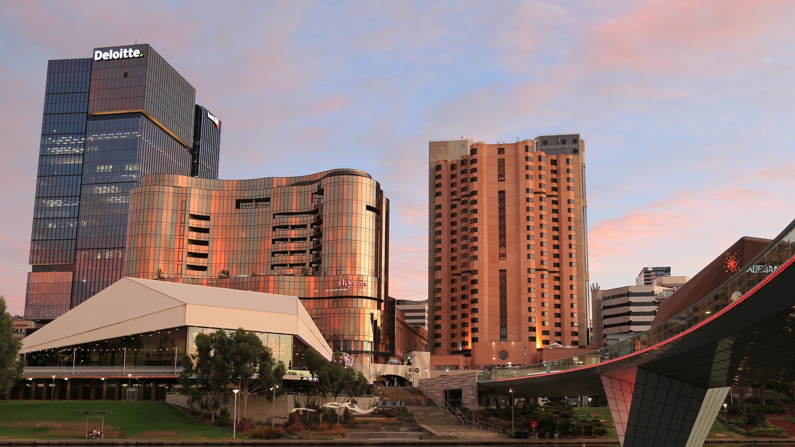 InterContinental Adelaide hotel tower beside the River Torrens and Adelaide Festival Centre at dusk