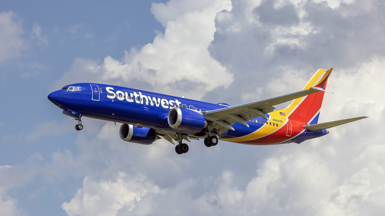 A Southwest Airlines Boeing 737-8 MAX, registration N9007K, on approach with landing gear extended, showing the Southwest titles and the red, yellow and blue tail.