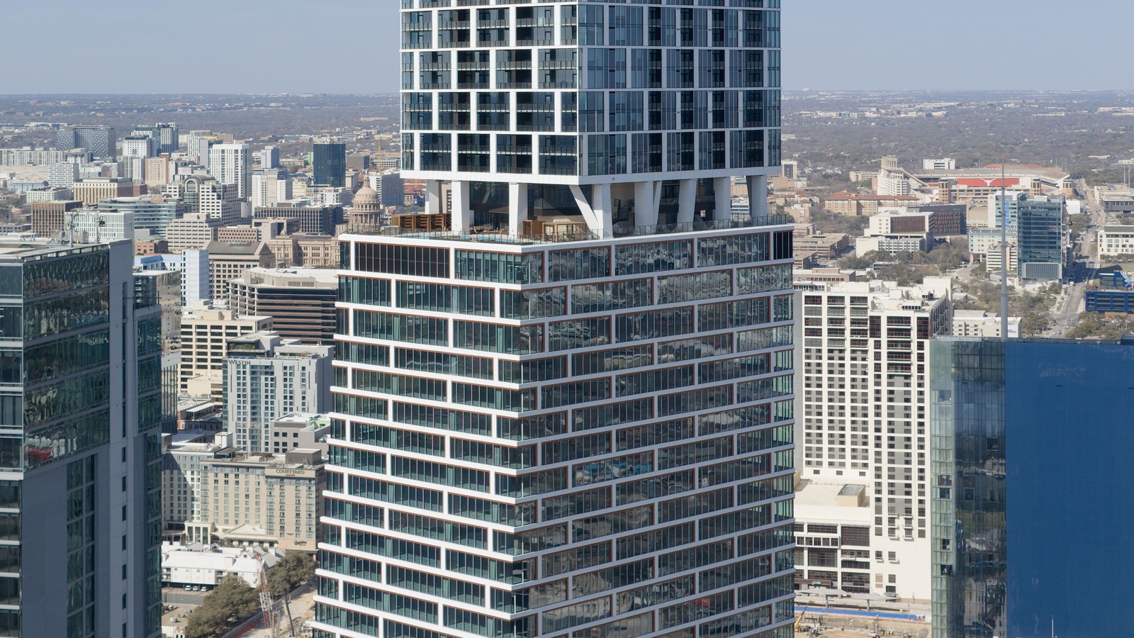 Waterline tower in downtown Austin housing 1 Hotel Austin, with downtown skyline in daylight