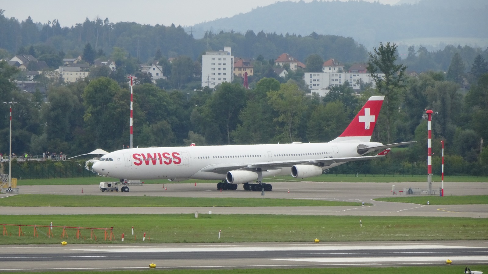 SWISS Airbus A340-300 on the taxiway at Zurich Airport with the Swiss cross on the tail
