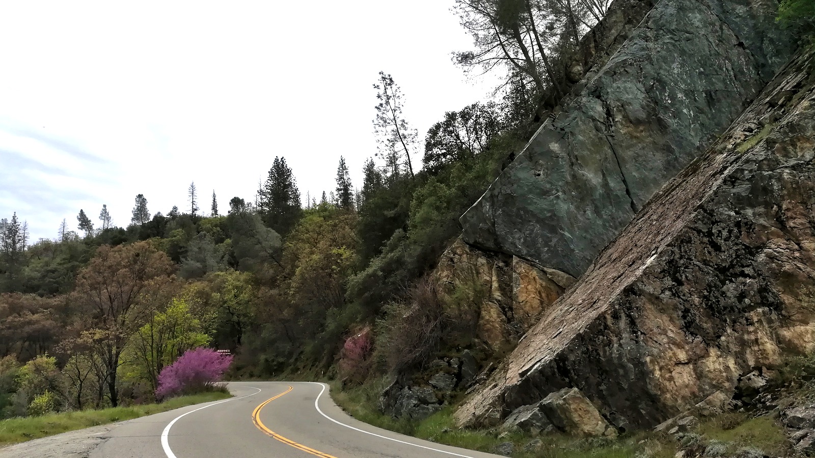California Highway 140 winding through a rock cut in the Merced River canyon west of Yosemite National Park