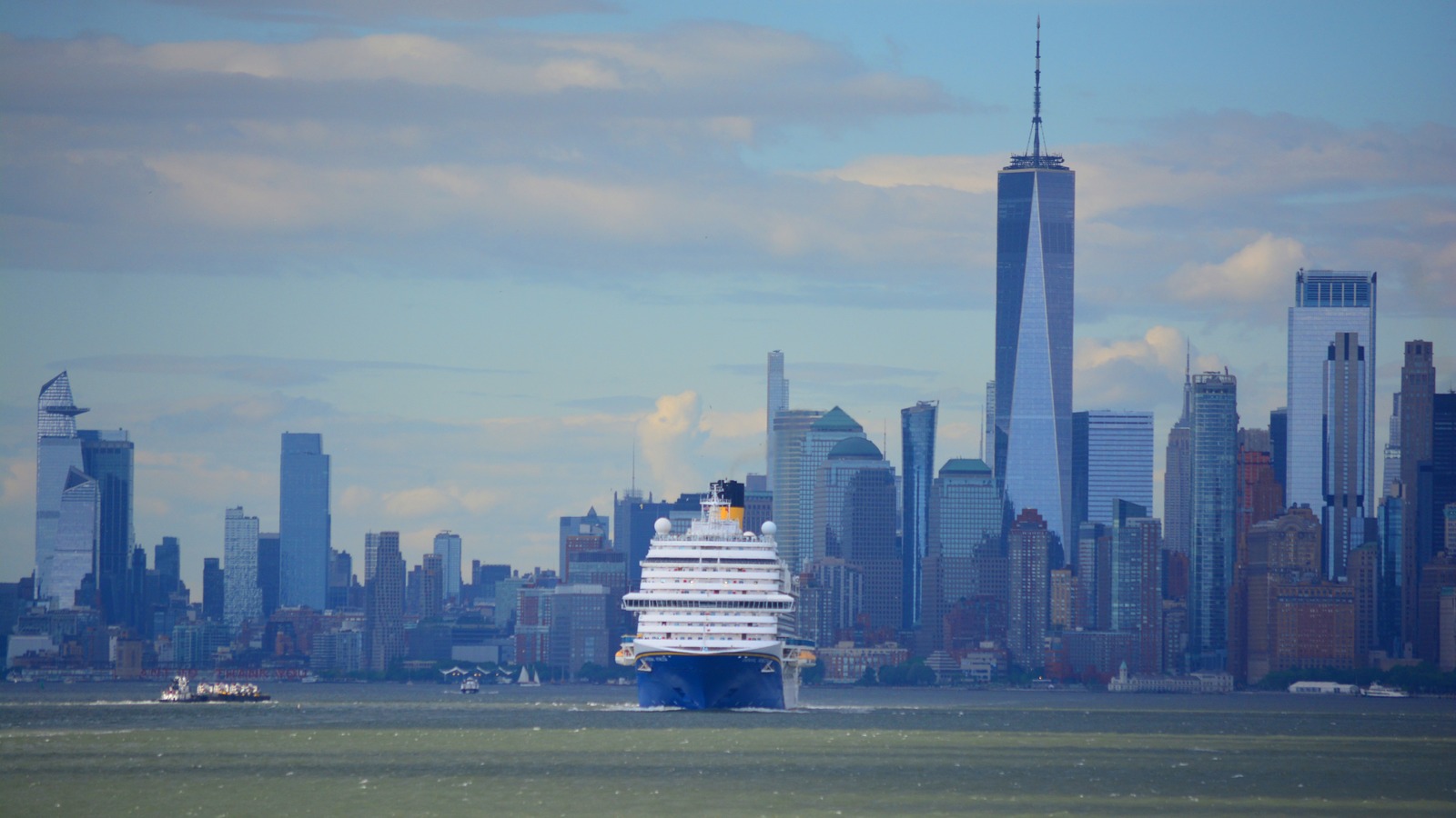 Carnival Venezia in New York Harbor with the Lower Manhattan skyline behind the ship