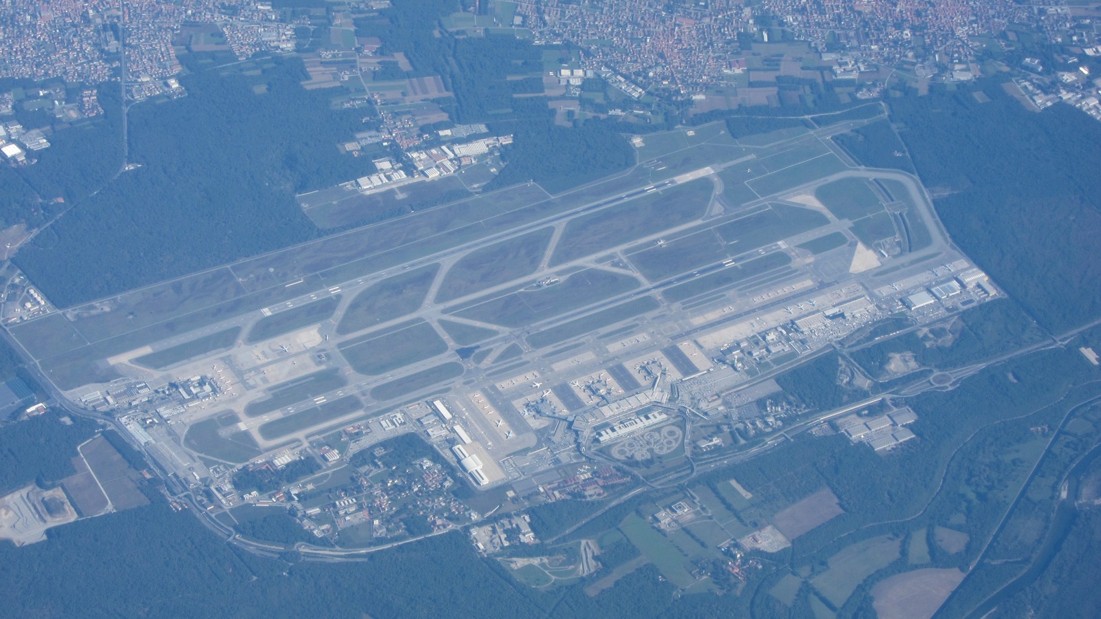 Aerial photograph of Milan Malpensa Airport showing both runways and the terminal complex