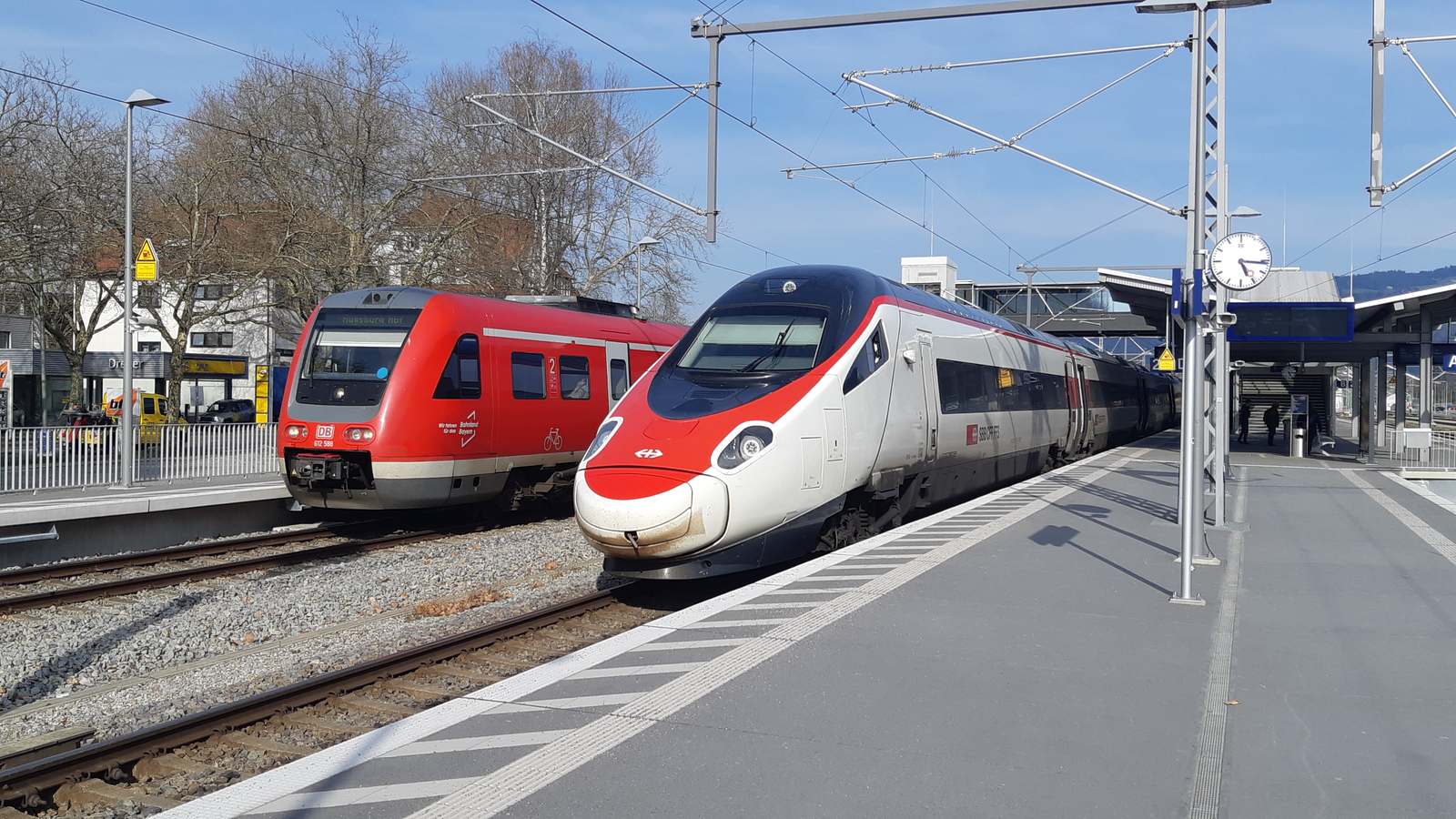 SBB Astoro EuroCity train beside a DB regional train at Lindau-Reutin station platform