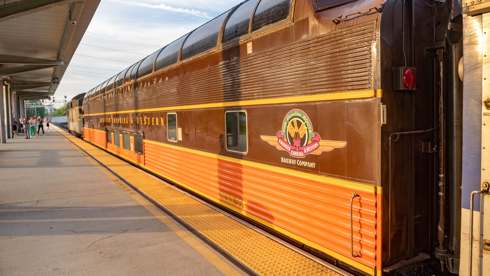 Aberdeen Carolina and Western Railway dome car with company crest at a North Carolina station platform