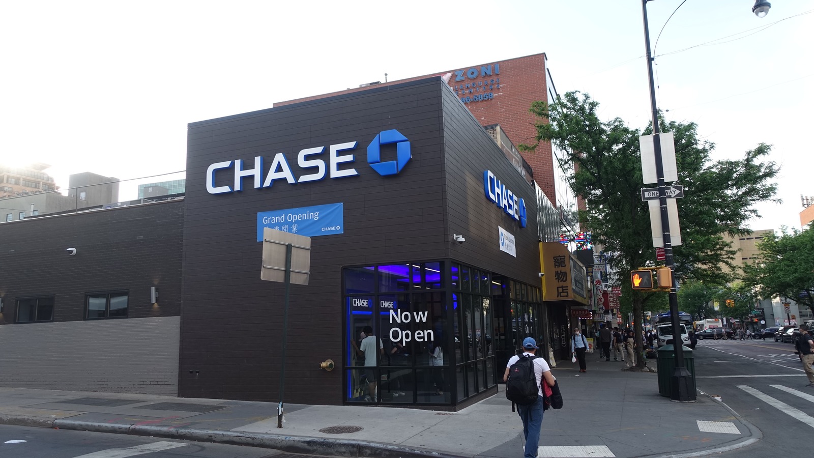 Chase bank branch exterior with Chase signs on a street corner in Flushing, Queens.