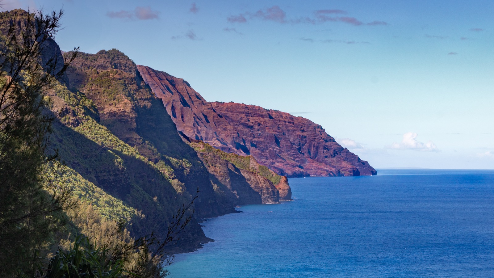 Na Pali Coast cliffs and blue ocean on Kauai, the coastline affected tour boats visit
