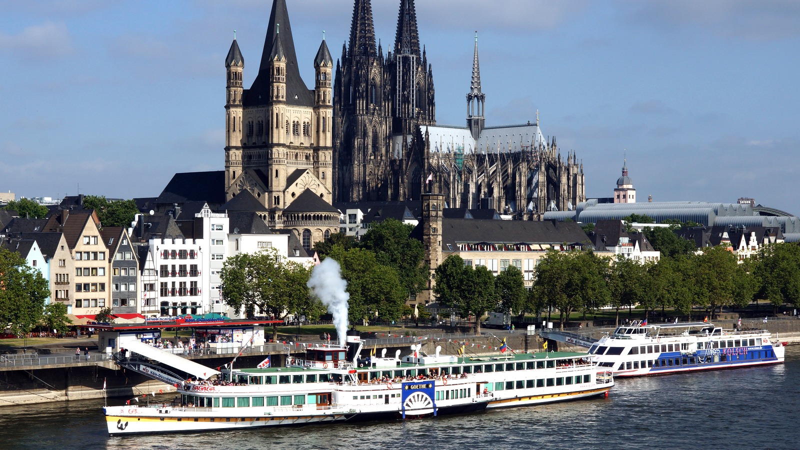 KD paddle steamer Goethe docked on the Rhine in Cologne with Cologne Cathedral behind it