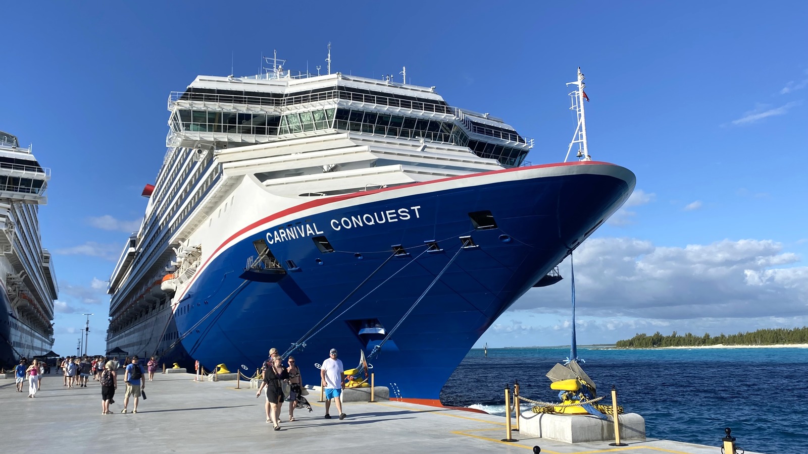 Carnival Conquest docked at Celebration Key in the Bahamas in February 2026, with the ship's name on the blue bow.