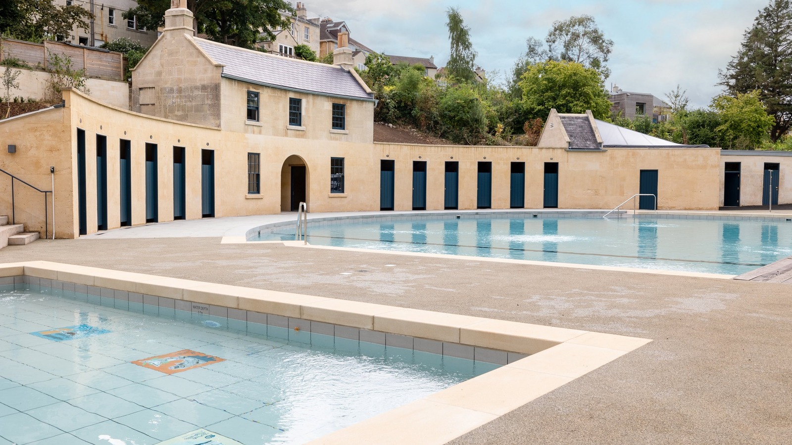 Archival press photograph of Cleveland Pools in Bath by Anthony Brown, showing the historic pool and buildings rather than current swimming operations