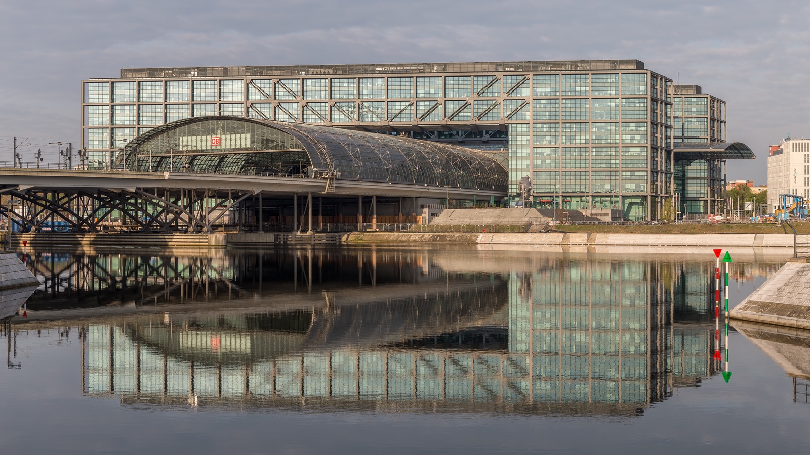 Berlin Hauptbahnhof east facade reflected in Humboldt Harbour at dawn