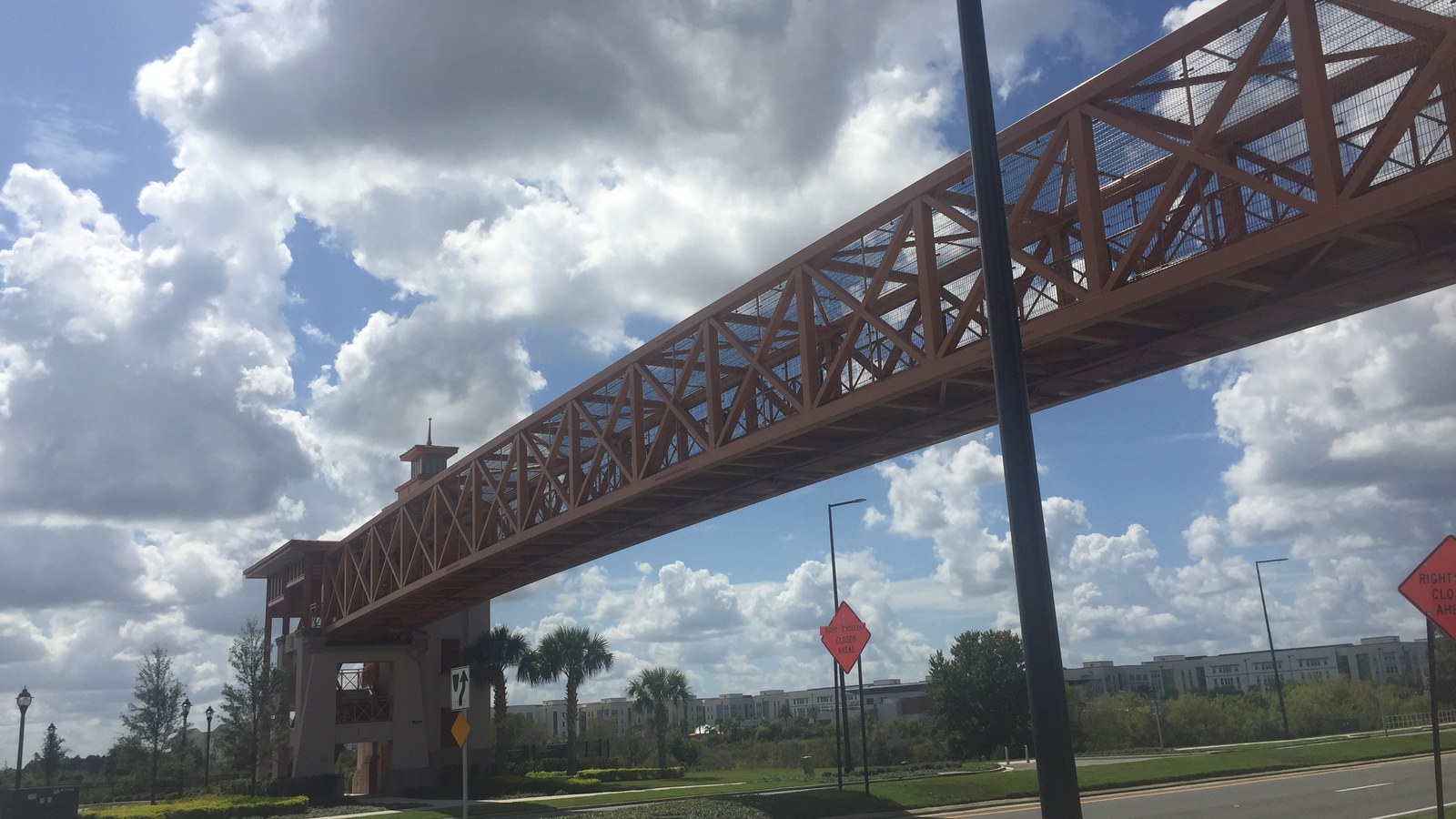The pedestrian skywalk over the road at Flamingo Crossings near Walt Disney World in October 2023, with hotels in the distance; the restaurant itself is not shown