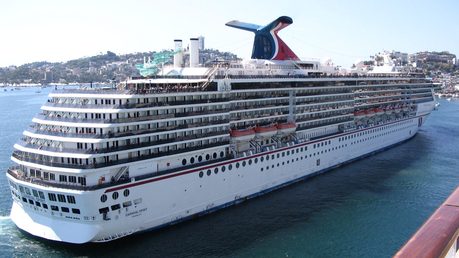 Carnival Spirit cruise ship docked in port viewed from the water on a clear day