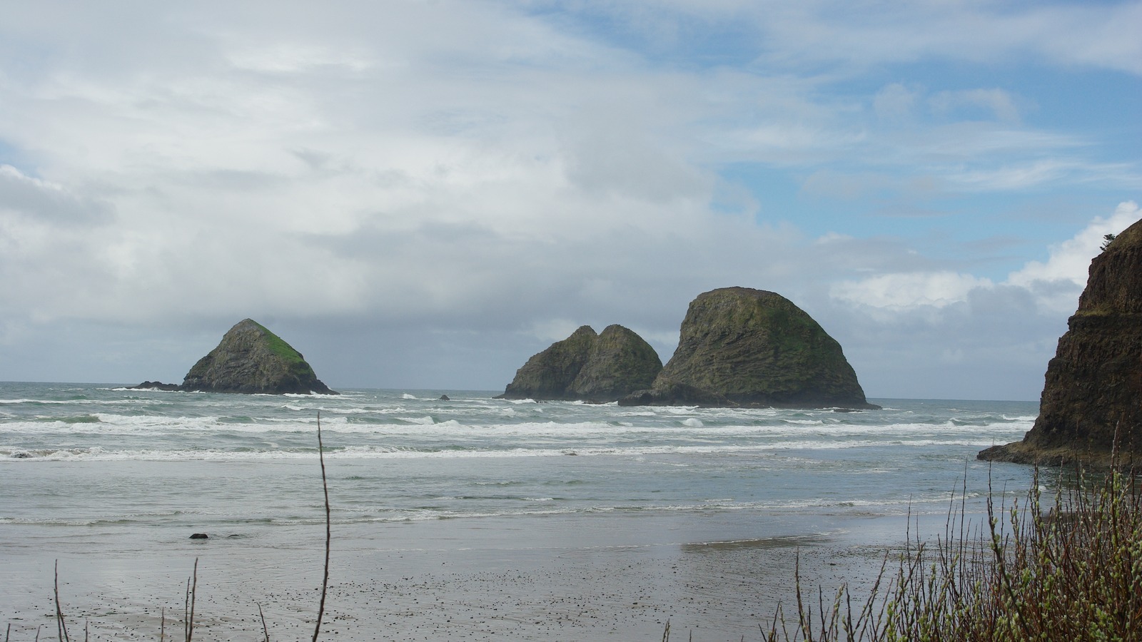 Three Arch Rocks viewed across the surf from Oceanside Beach in Oregon