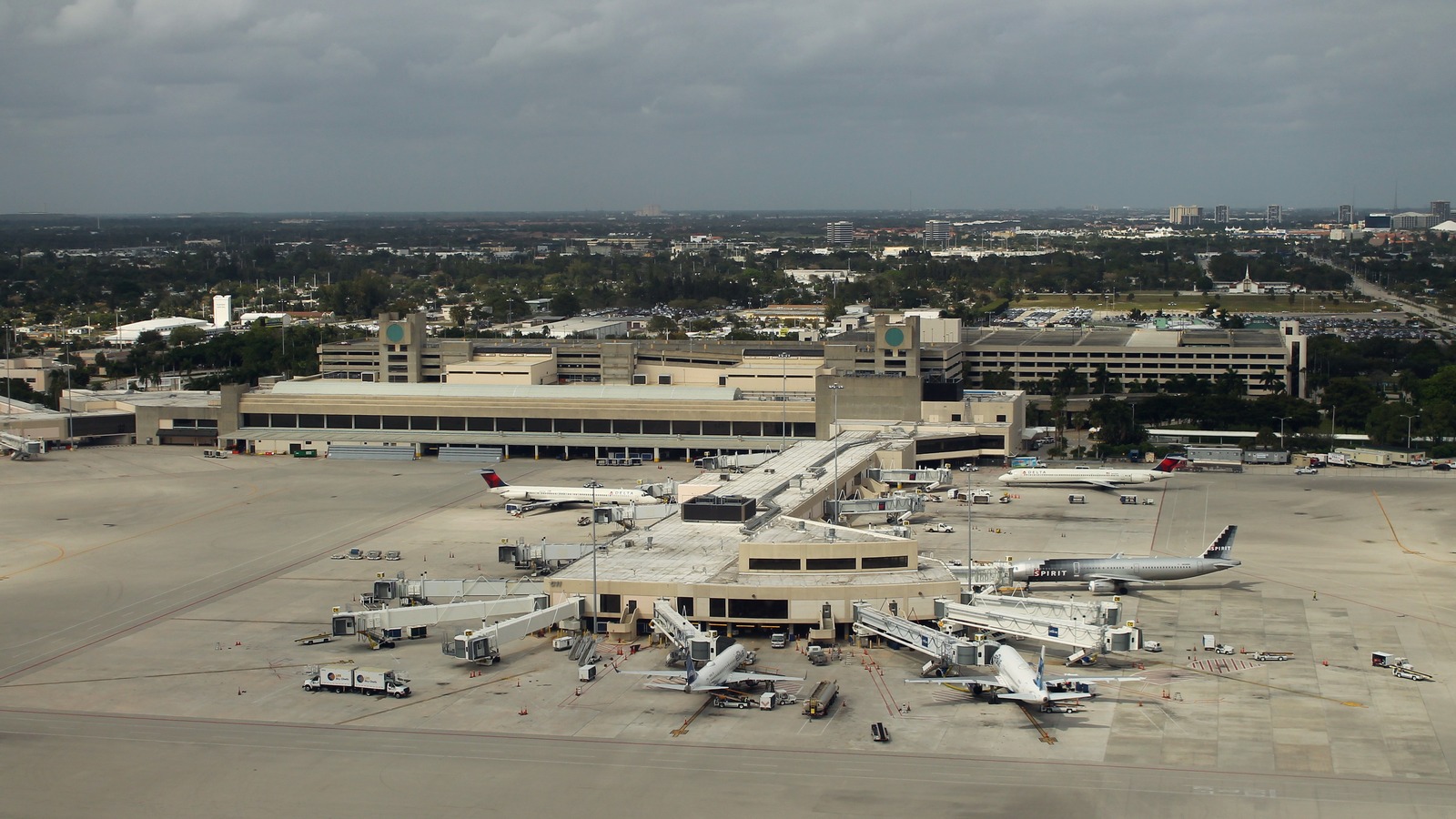 Aerial view of Palm Beach International Airport Concourse C, jet bridges, and parked airliners in West Palm Beach, Florida