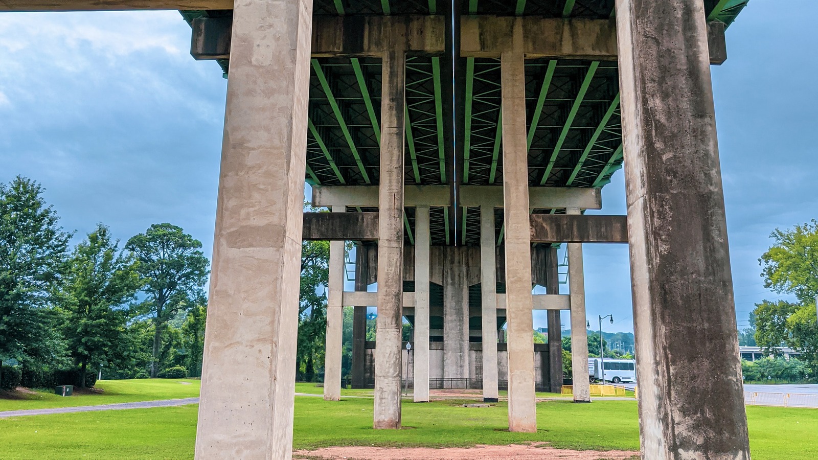 Daytime view of highway overpass pillars and green lawn in Tuscaloosa, Alabama