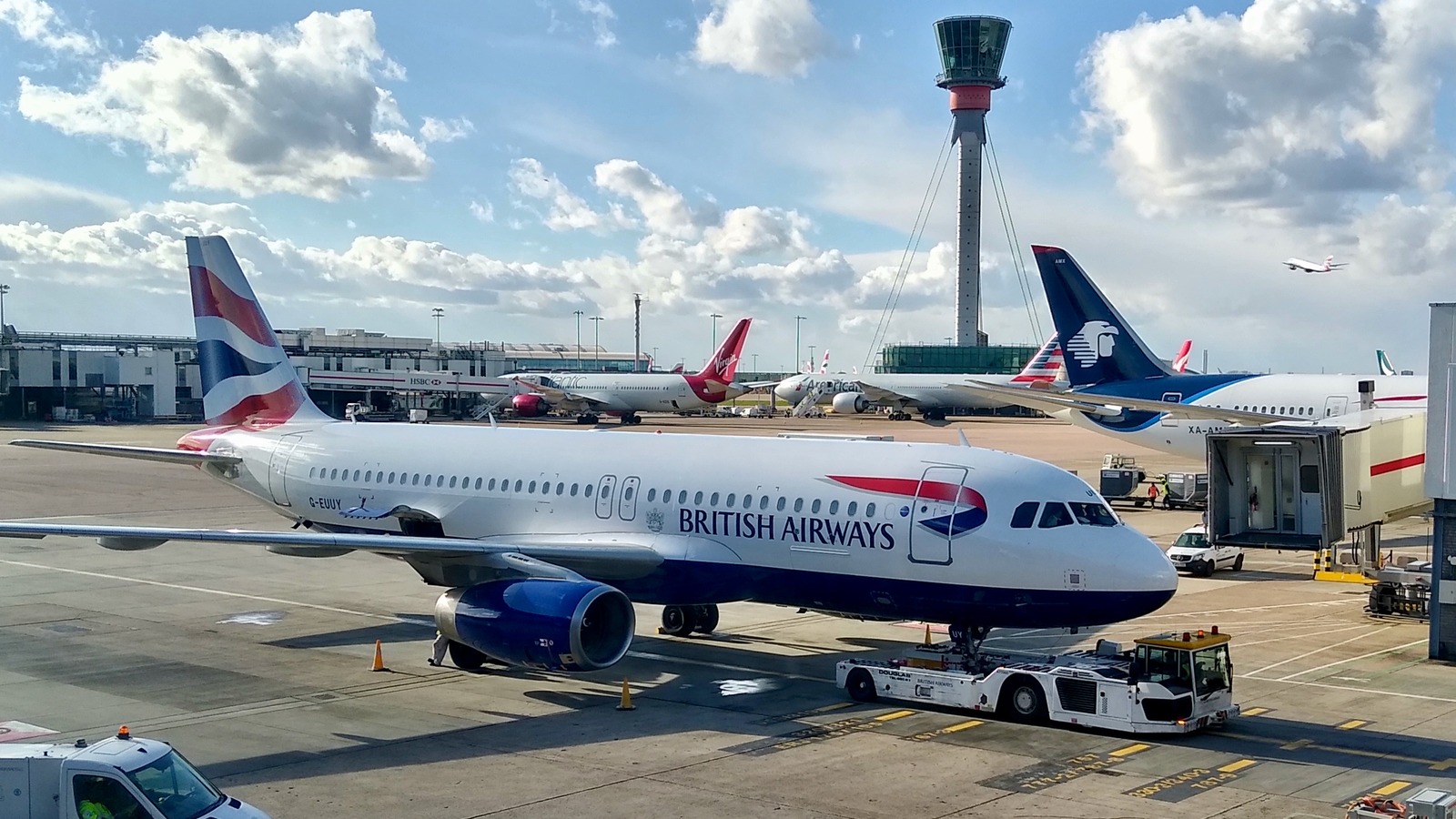 British Airways aircraft at Heathrow Terminal 3 with the airport control tower in March 2023