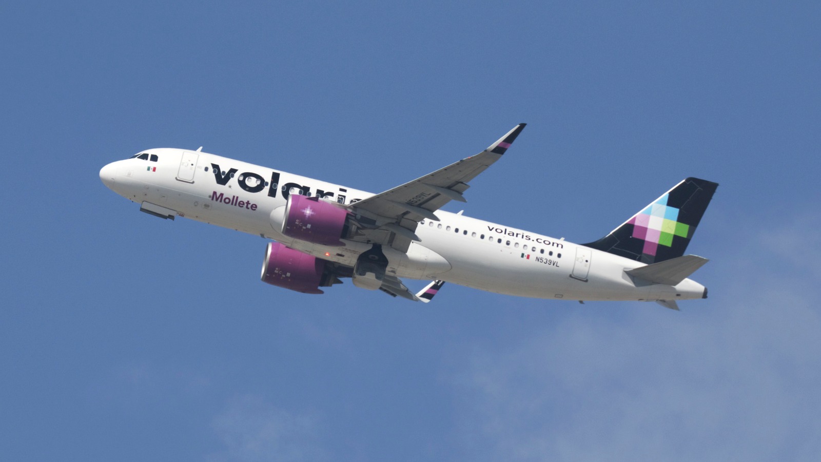 Volaris Airbus A320neo N539VL climbing after takeoff, Mexican flag visible on the forward fuselage.
