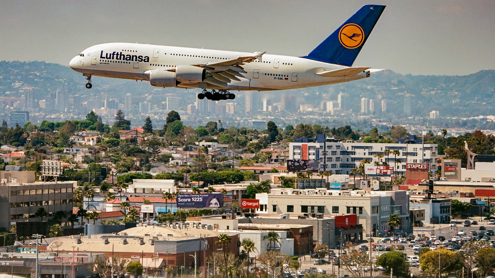 A Lufthansa Airbus A380 on final approach to Los Angeles International Airport above the city