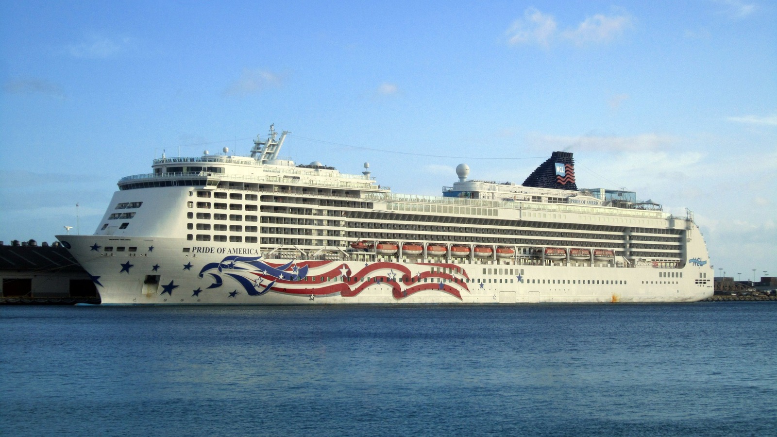 Pride of America alongside in Honolulu Harbor with the ship's American-flag hull art visible