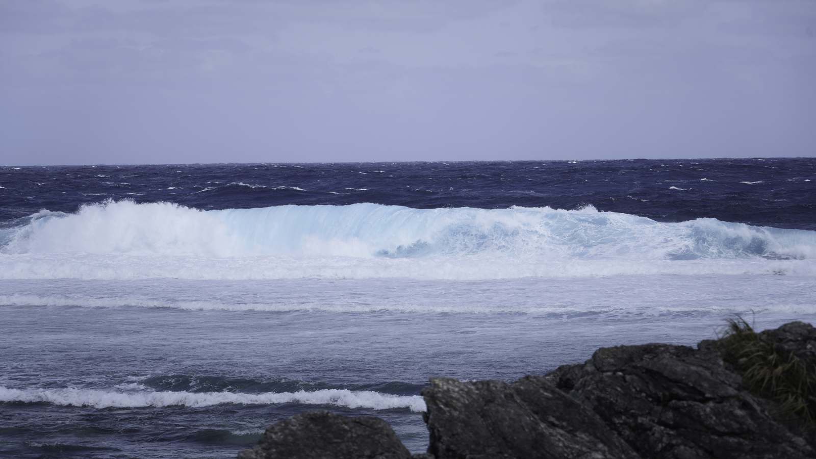 Large breaking waves off the rocky northern coast of Iheya Island in Okinawa