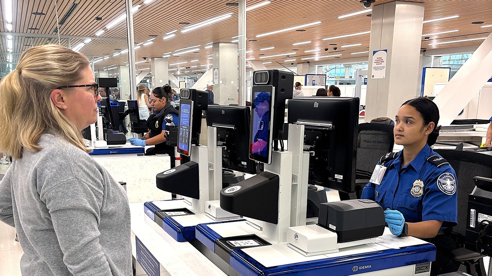 Traveler and TSA officer at a CAT-2 identity checkpoint at Denver International Airport