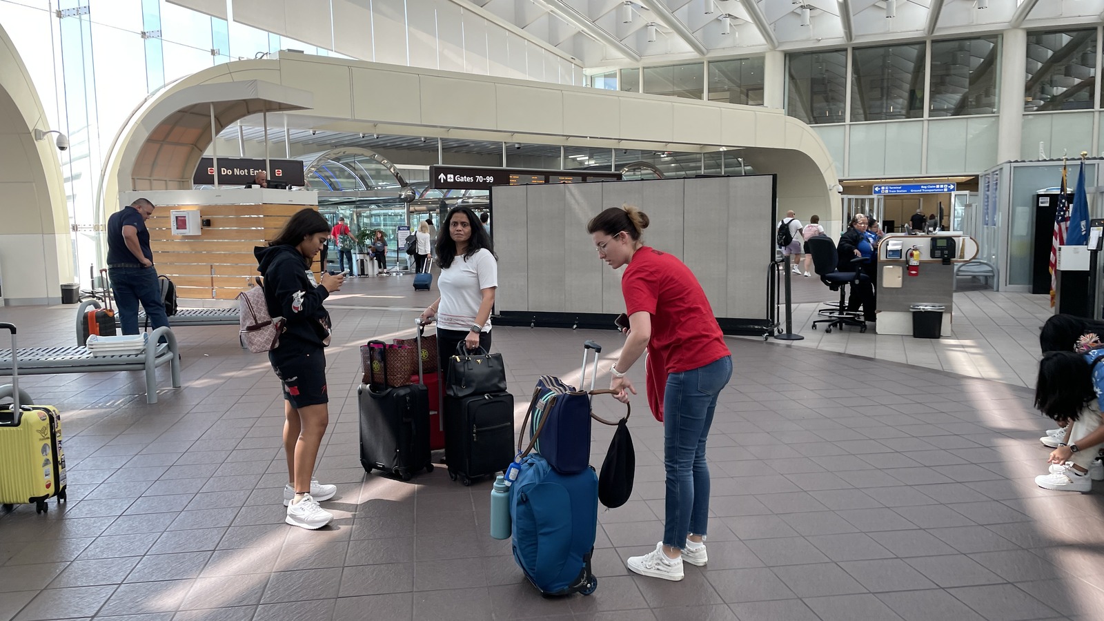 Travelers with luggage near the TSA security checkpoint at Orlando International Airport