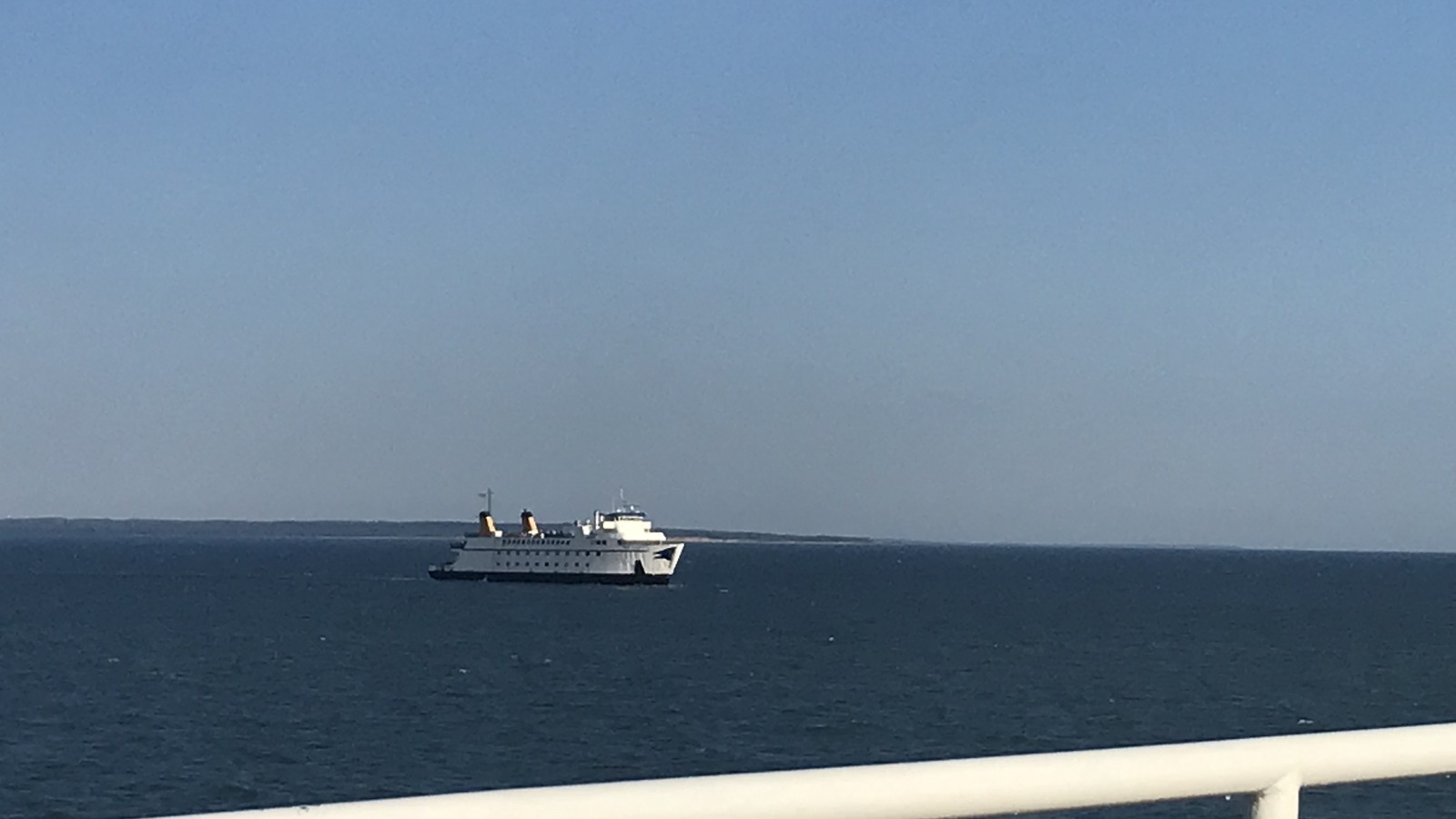 A white Cross Sound Ferry vessel with twin buff stacks underway on open water near Orient Point.