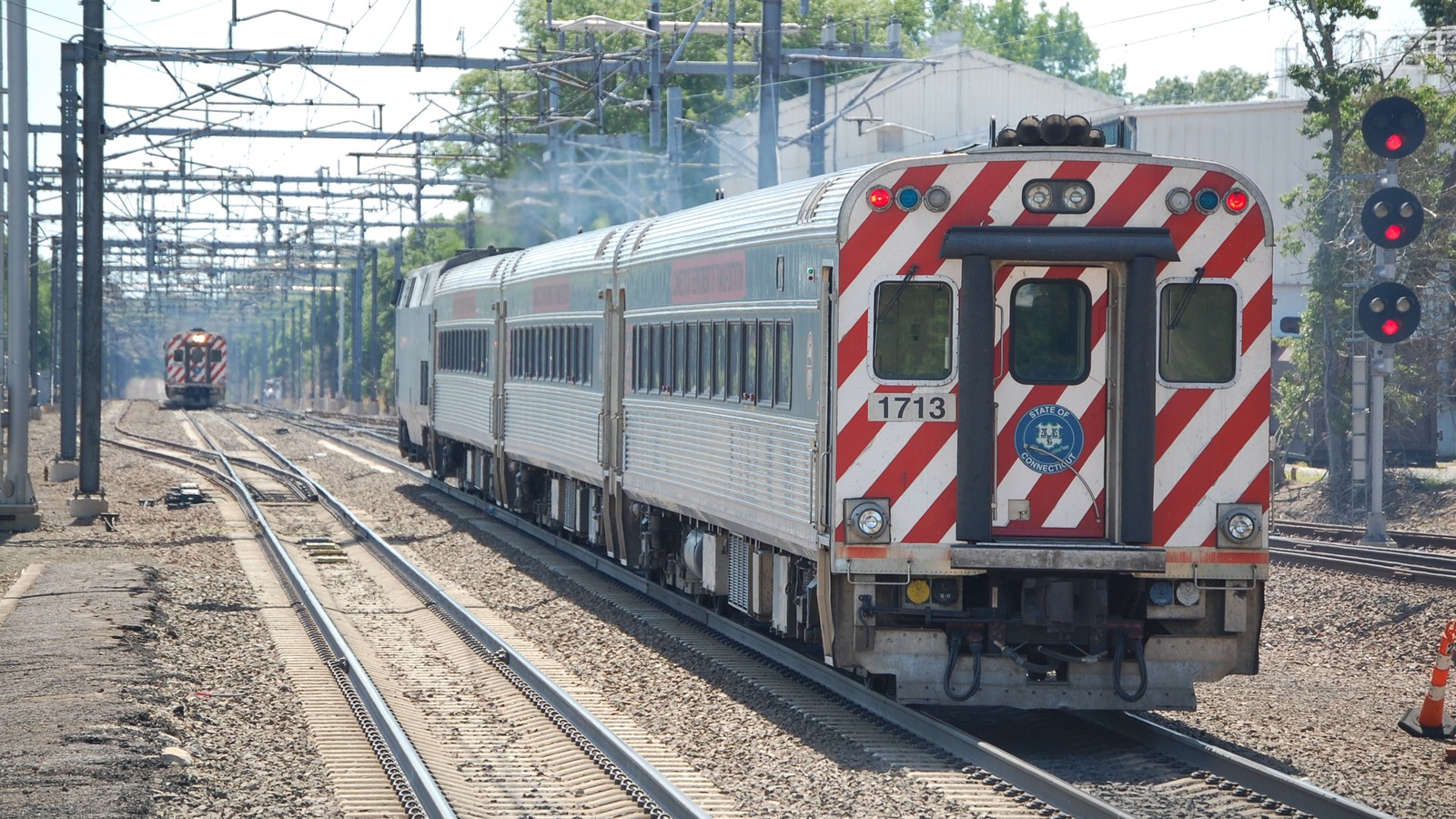 A westbound Shore Line East train departing Old Saybrook in June 2018, an archival view of the Connecticut rail system