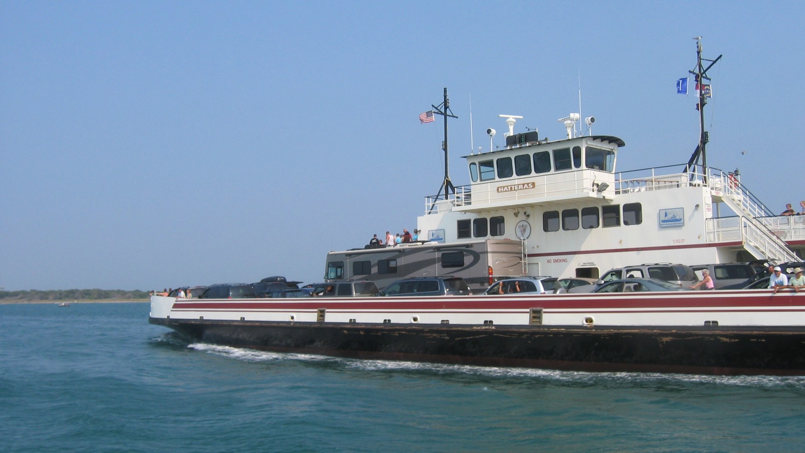 Hatteras vehicle ferry crossing Hatteras Inlet with cars and an RV on deck