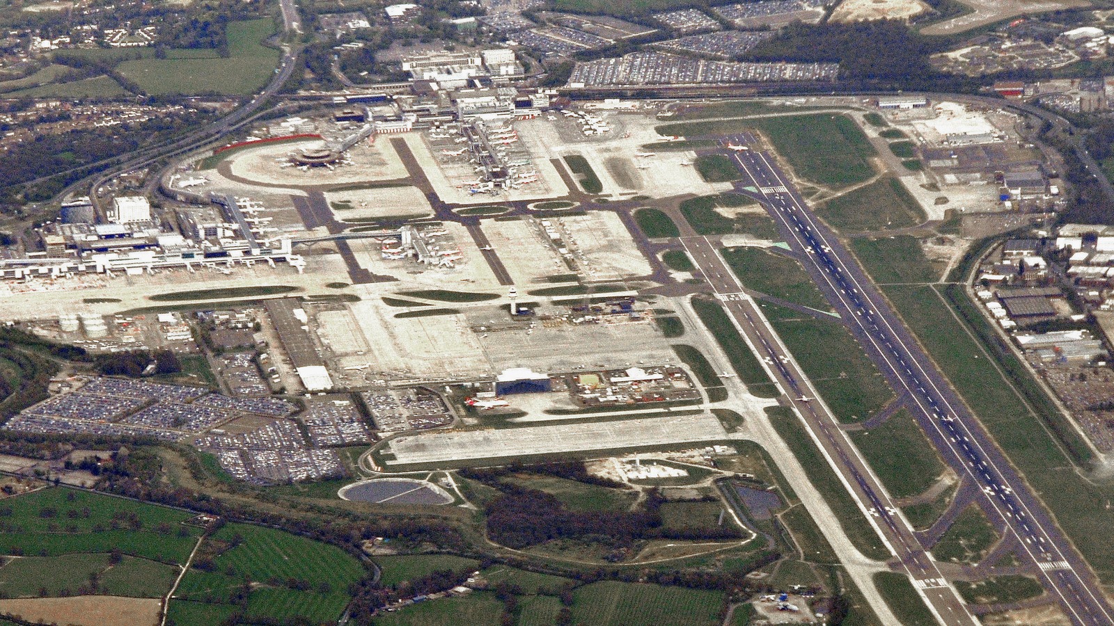 Aerial view of London Gatwick Airport showing the single main runway, taxiways, and terminal complex