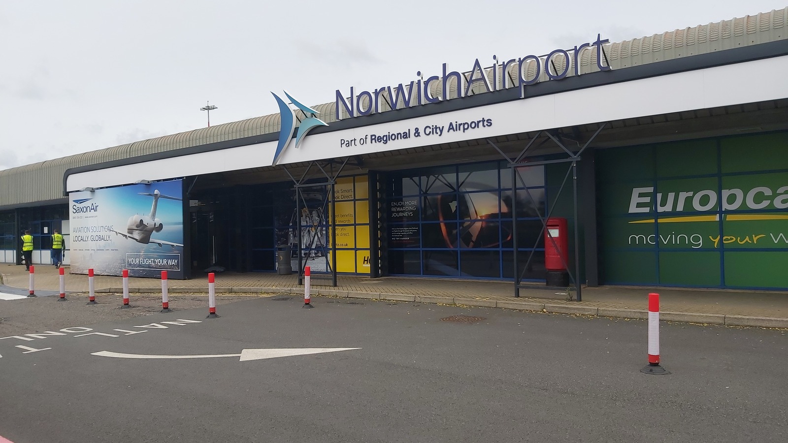 Entrance to Norwich Airport terminal with the Norwich Airport sign over the doors