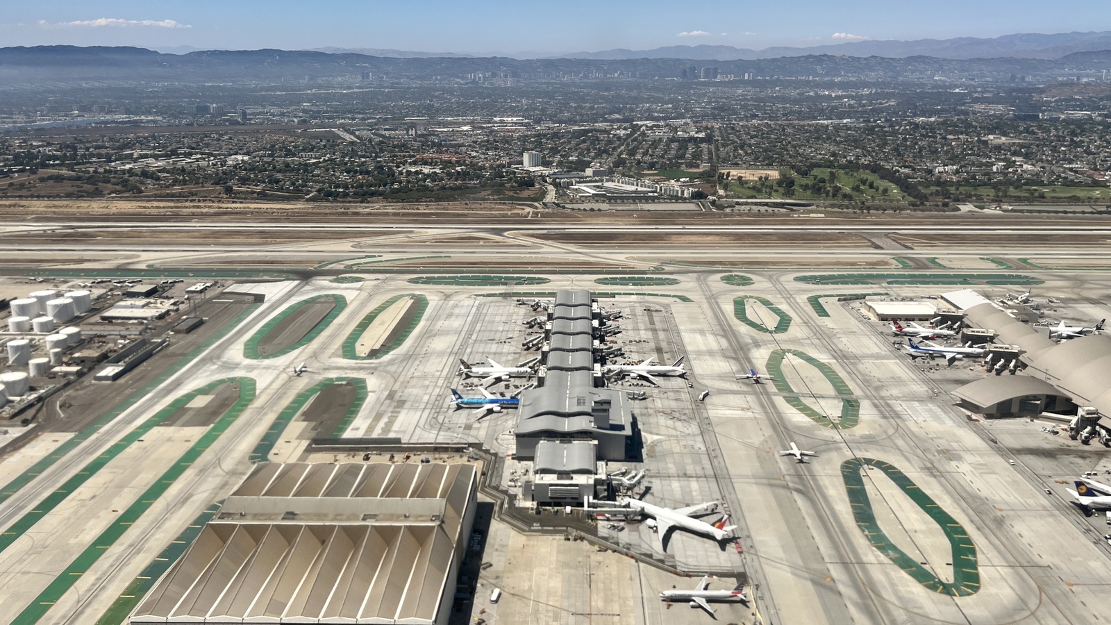 Aerial view of Los Angeles International Airport showing the Tom Bradley International Terminal concourse, parked airliners and the airfield taxiways