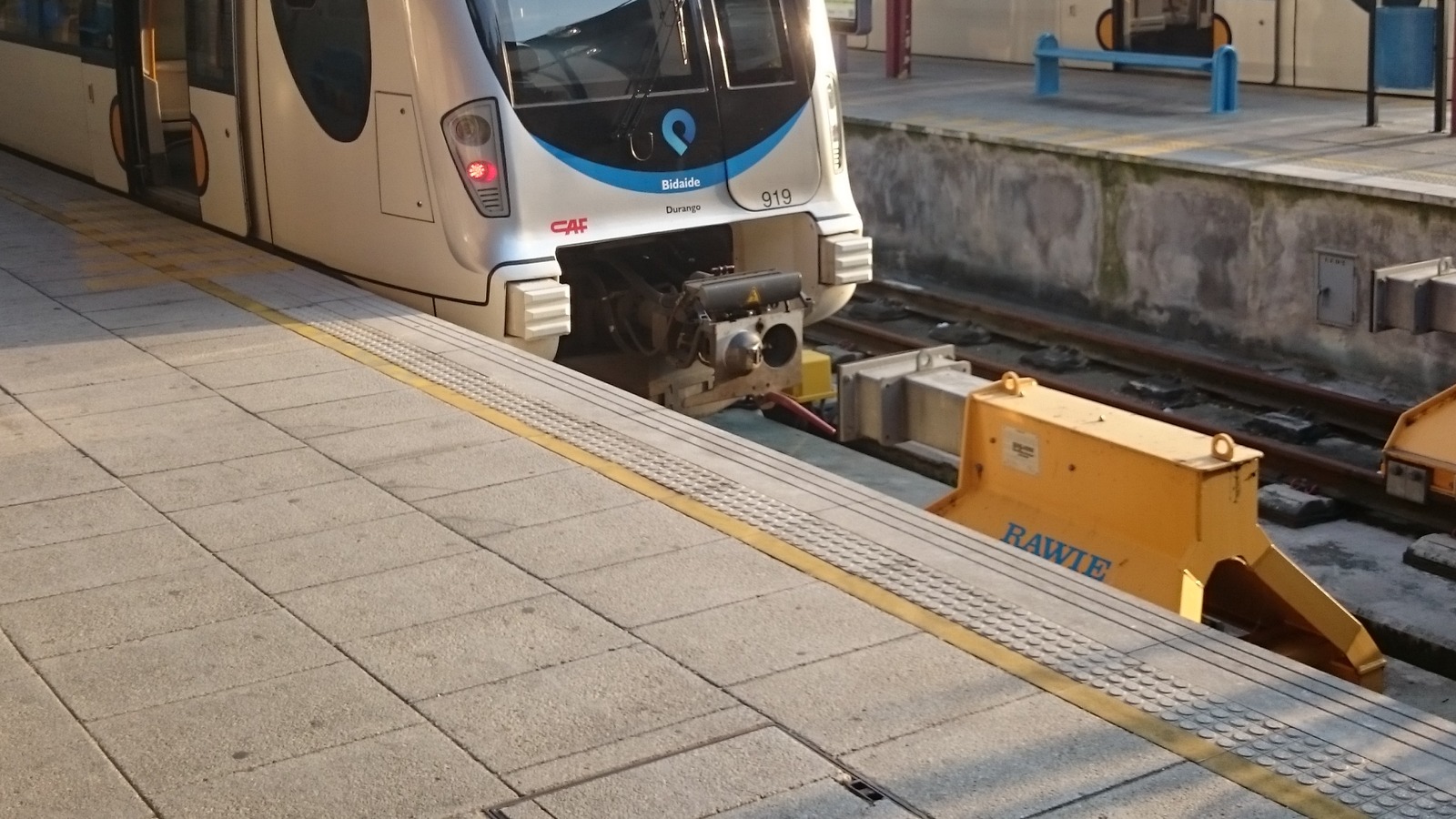 An Euskotren train at a Basque Country platform, unit 919 with Bidaside and Durango markings