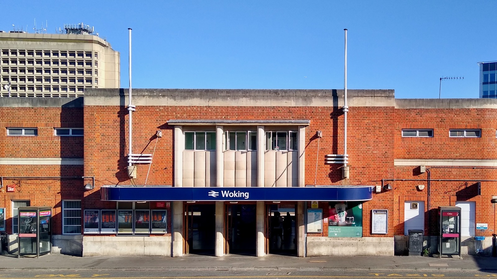 South entrance of Woking railway station in Surrey, the main-line hub that loses named Waterloo and Exeter calls from 4 October 2026.