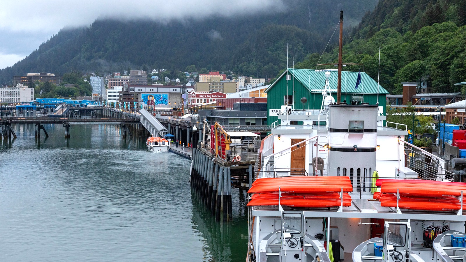 Juneau cruise ship dock and waterfront with town buildings and forested mountains