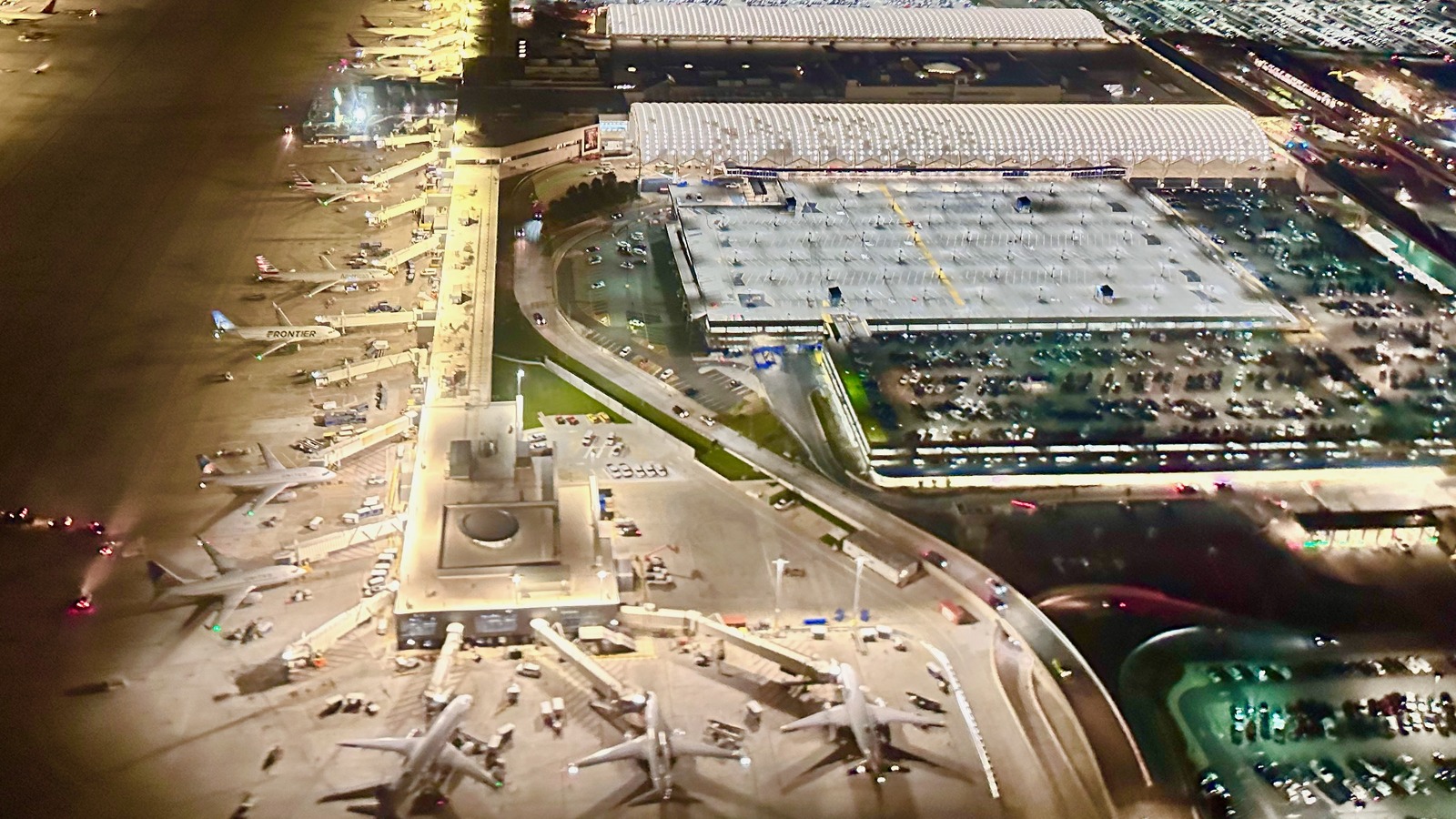 Night aerial view of Hartsfield-Jackson Atlanta International Airport terminals, concourses, and parked aircraft