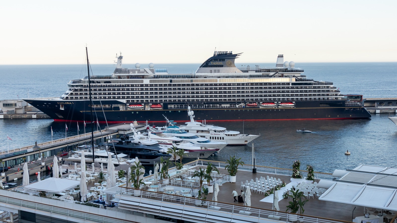 Explora I cruise ship at the dock in Monaco, with the name EXPLORA I visible on the bow and funnel.