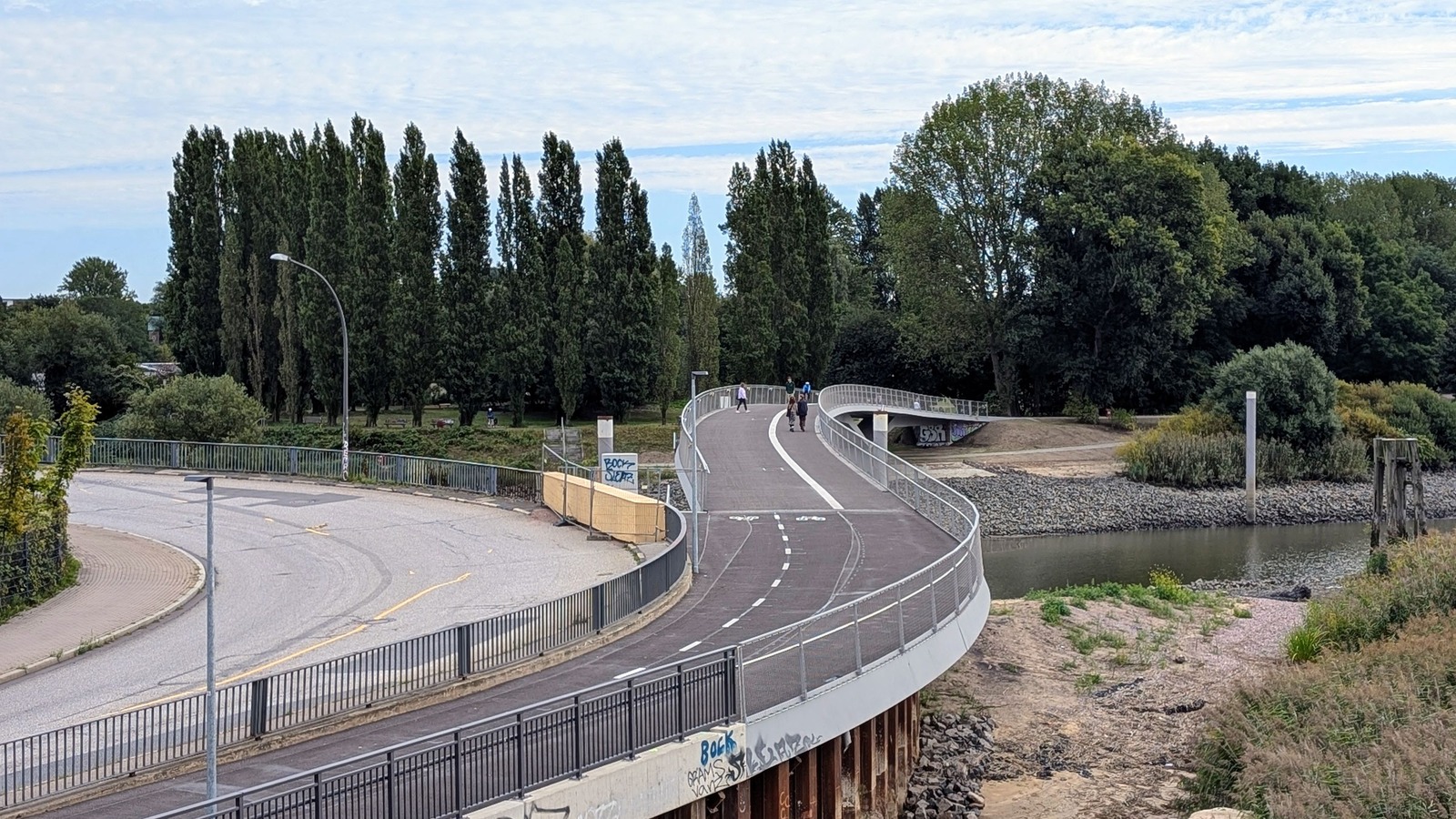 New Entenwerder walking and cycling bridge curves toward the park in Hamburg, photographed September 11, 2026