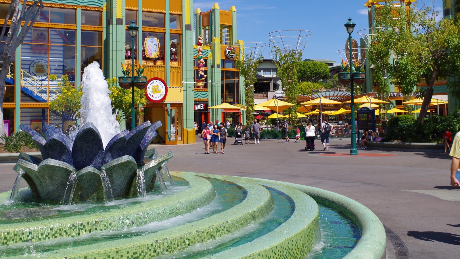 Downtown Disney District in Anaheim with the fountain and shops near Build-A-Bear on a clear day