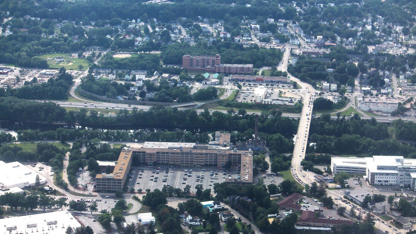 Aerial view of the Queen City Avenue Bridge crossing the Merrimack River in Manchester, New Hampshire.