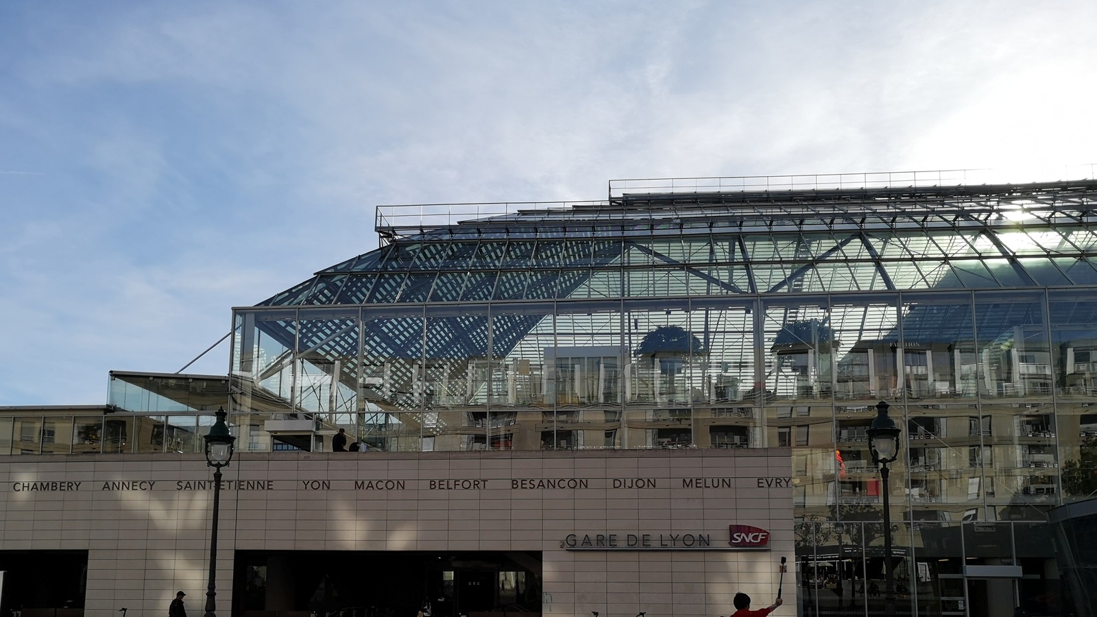 Daylight exterior of Paris Gare de Lyon station entrance with SNCF signage, served by RER A, RER D and Transilien Line R