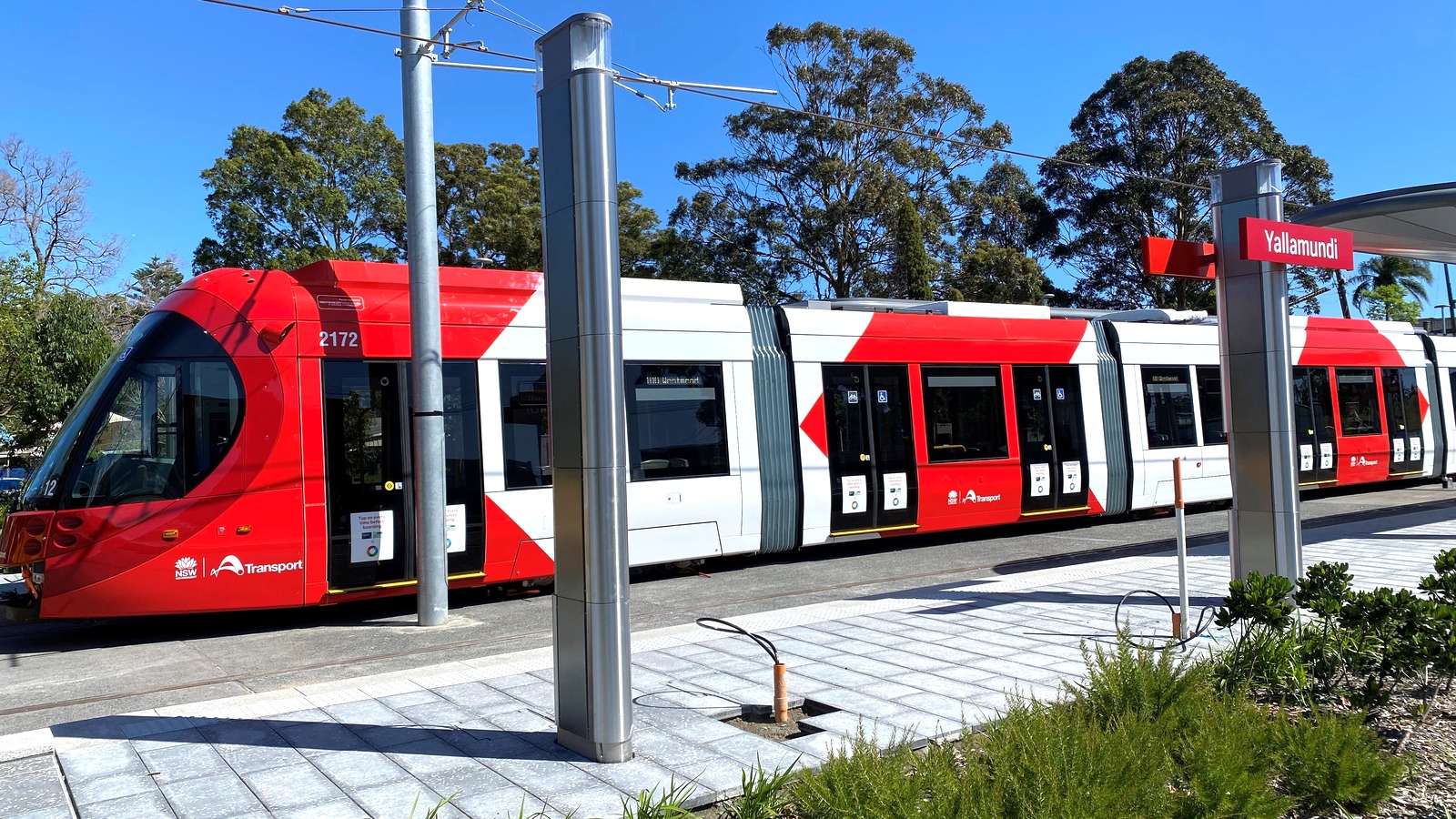 Parramatta Light Rail tram at Yallamundi stop under a clear sky