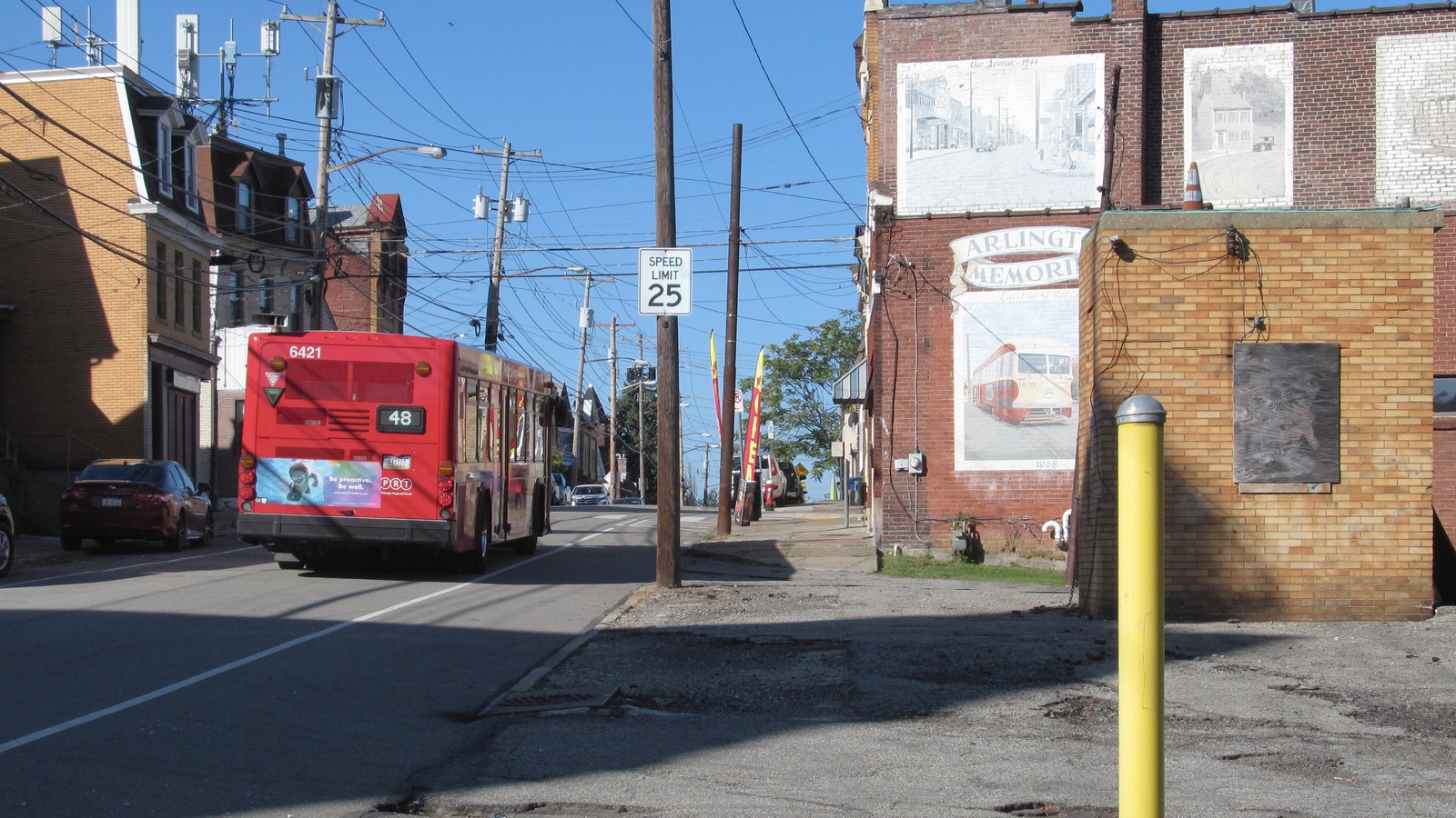 A red Pittsburgh Regional Transit Route 48 bus on a street in Arlington in October 2024.