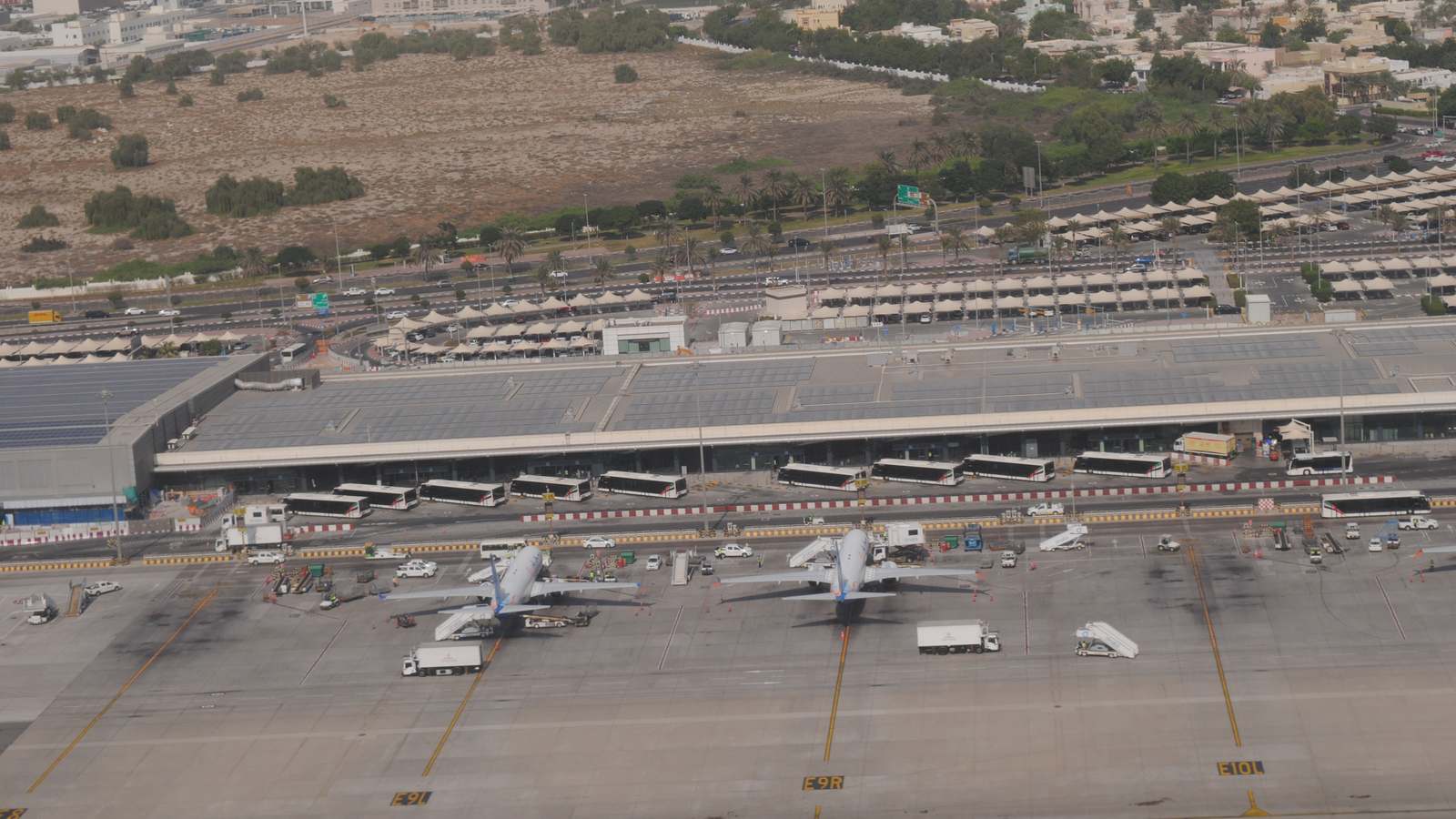 Aerial view of Dubai International Airport Terminal 2 with aircraft parked on the apron