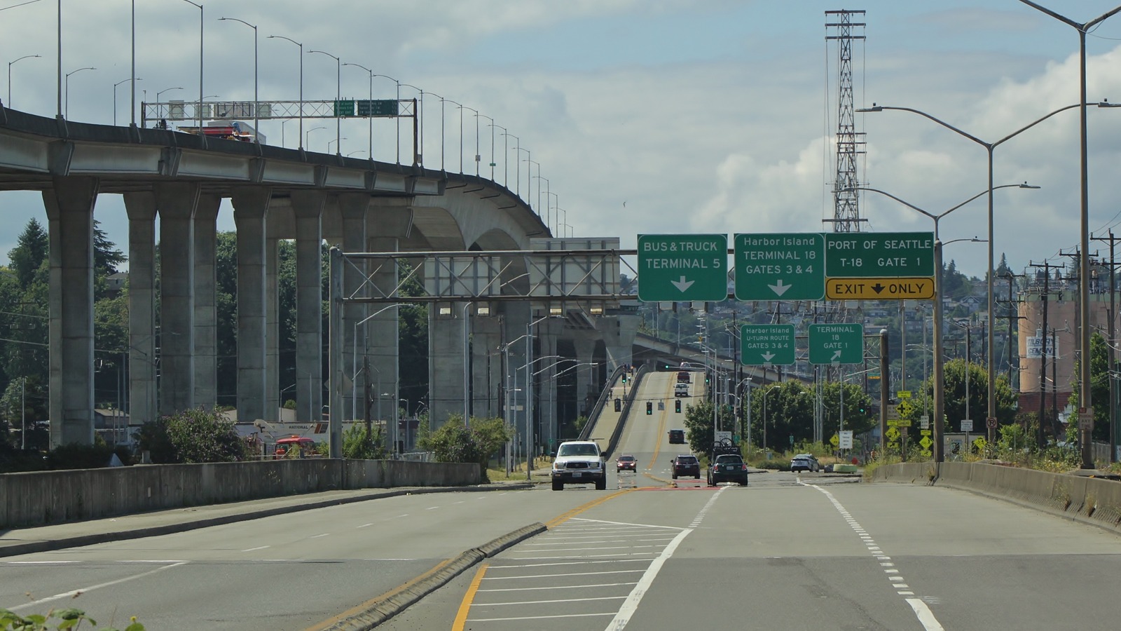 West approach to the Spokane Street Swing Bridge in Seattle, with the West Seattle Bridge high-rise at left and Port of Seattle terminal signs overhead